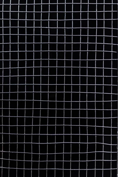 Griglia metallica su sfondo nero — Foto Stock