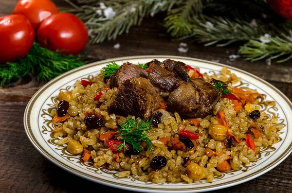 Uzbek national dish pilaf on a dark wooden background with pickl — Stock Image Uzbek national dish pilaf on a dark wooden background with pickl Royalty Free Stock Photos