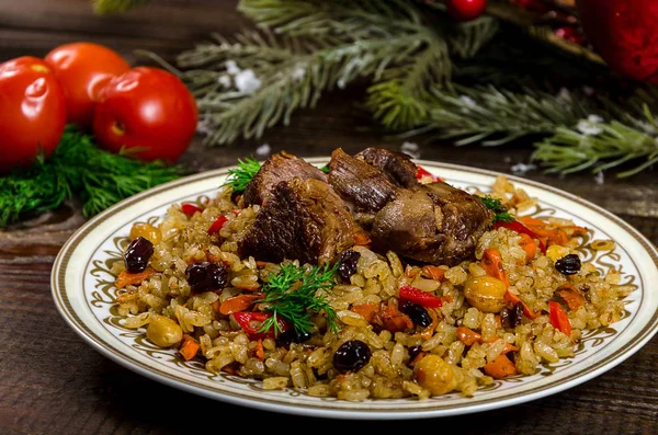 Uzbek national dish pilaf on a dark wooden background with pickl — Stock Image Uzbek national dish pilaf on a dark wooden background with pickl Royalty Free Stock Photos