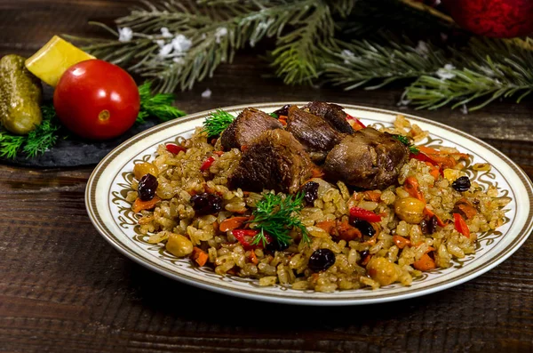 Uzbek national dish pilaf on a dark wooden background with pickl — Stock Image Uzbek national dish pilaf on a dark wooden background with pickl Stock Photo