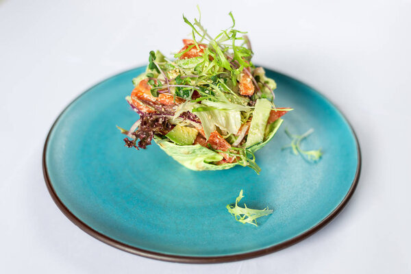 Vegetable vegetarian salad in a blue plate