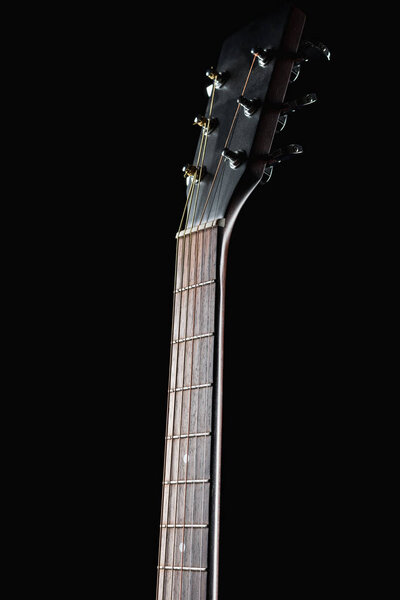 Guitar neck on a black background