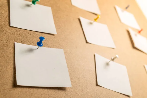 white stickers for notes on a cardboard background