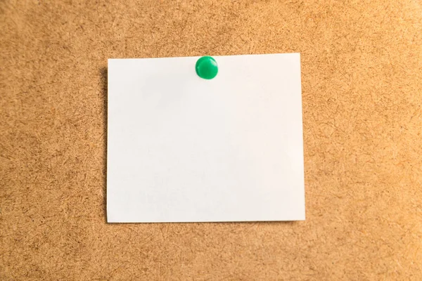 white sticker for notes on a cardboard background