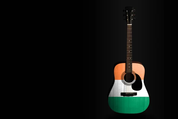 Acoustic concert guitar with a drawn flag Ireland, on a dark background, as a symbol of national creativity or folk song.