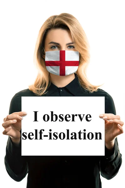 Girl with blond hair in a mask with the flag of England and a sheet with the inscription \