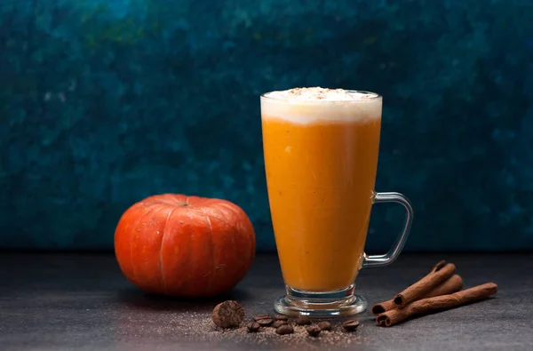 pumpkin latte smoothies with spices on a wooden table