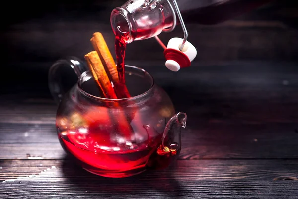 Hot wine mulled wine in a glass teapot in a bottle