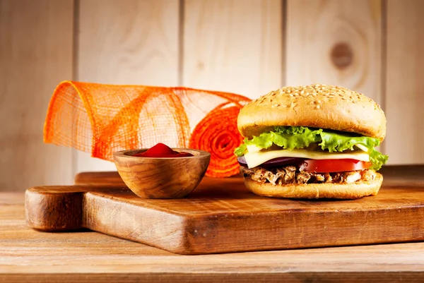 Fastfood Burgers with meat turkey, cheese and vegetables on a rustic background