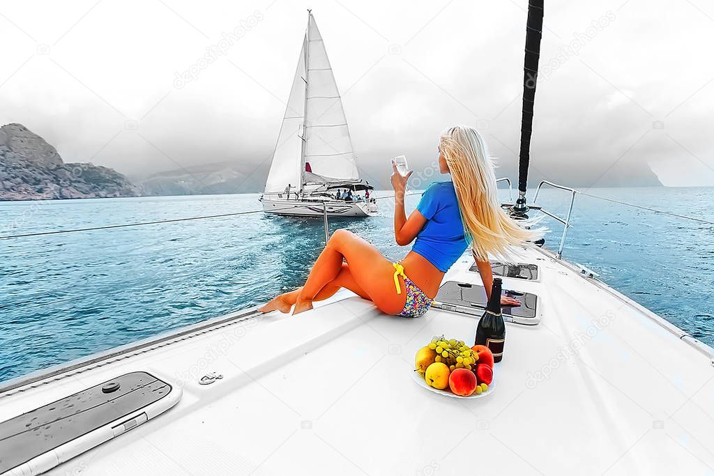 Beautiful blonde on a yacht. Two yachts