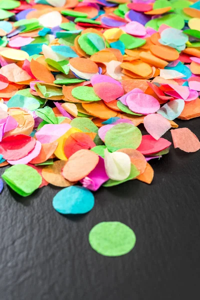 Confetti colorati su scisto nero come modello per la celebrazione — Foto Stock