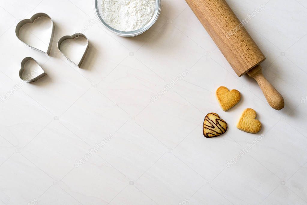 Cookies in heart shape lying after baking decorative with rollin