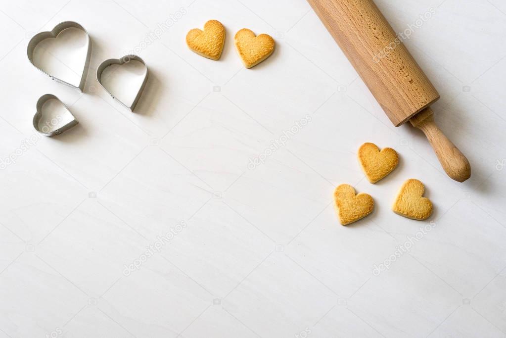 delicious Cookies in heart shape lying after baking decorative w
