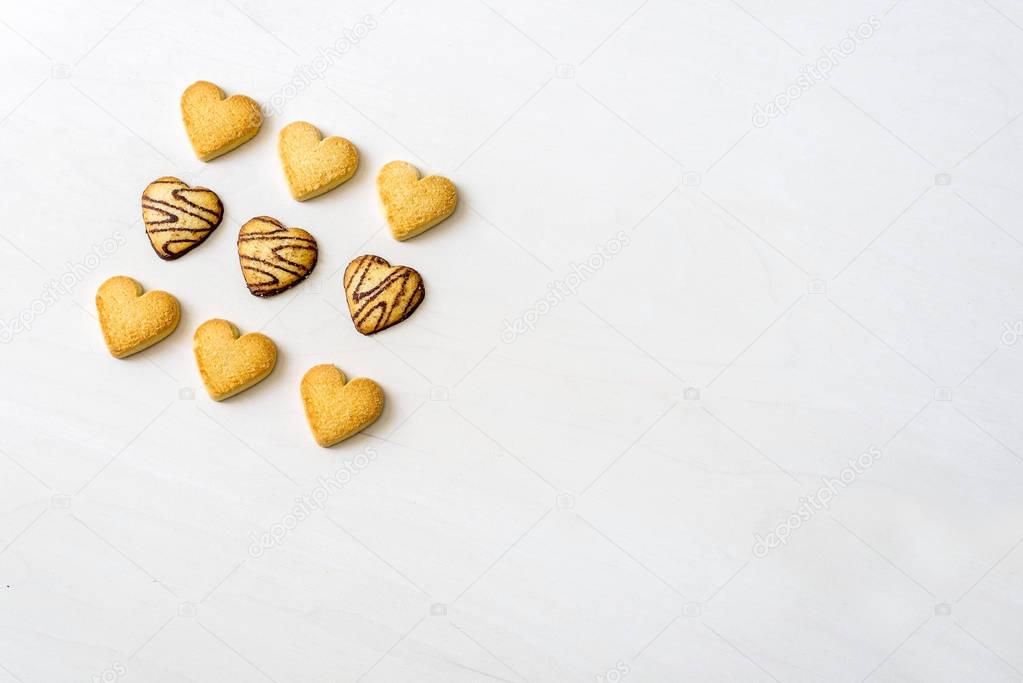 delicious Chocolate Cookies in heart shape lying after baking de