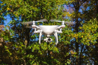 Beyaz dron kamera önünde ağaçlar uçan resim