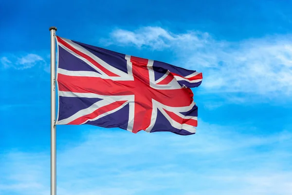 British union jack flag waggling in the wind with sky — Stock Photo, Image