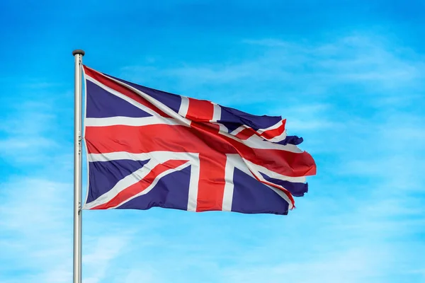 British union jack flag waggling in the wind with sky — Stock Photo, Image