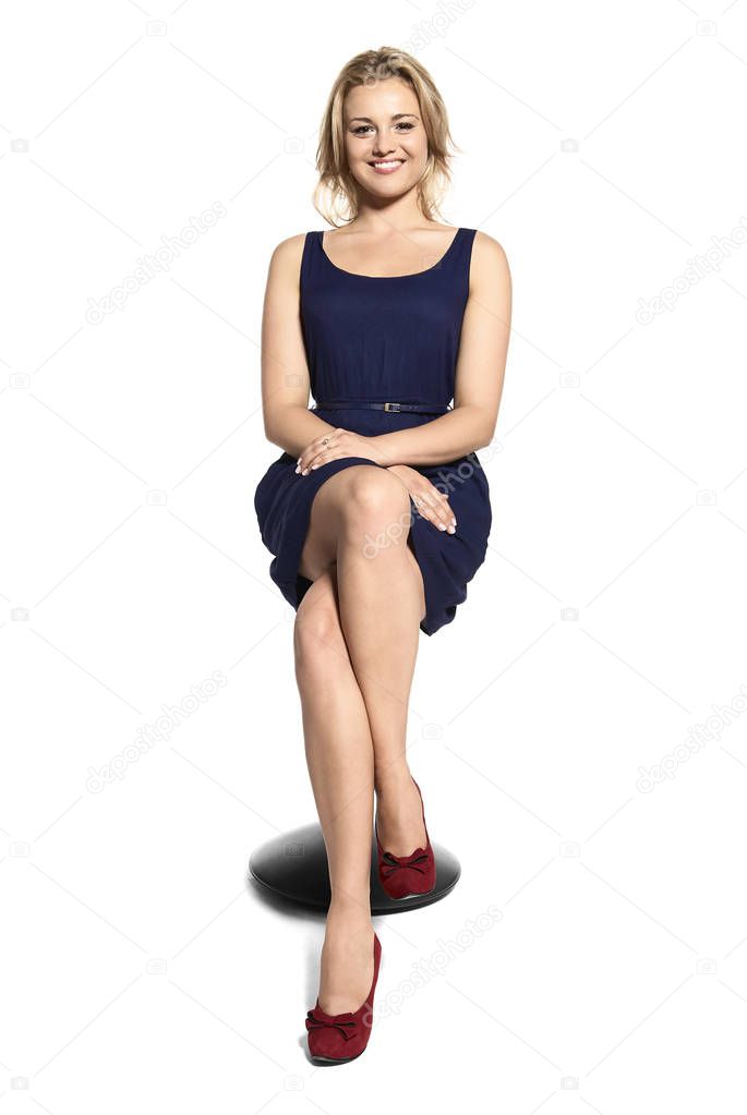Smiling Young Woman Sitting on a Stool