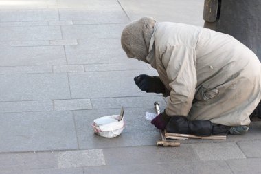 ST PETERSBURG, RUSSIA - MARCH 24 : The poor man on the street of St. Petersburg on March 24 2016. clipart
