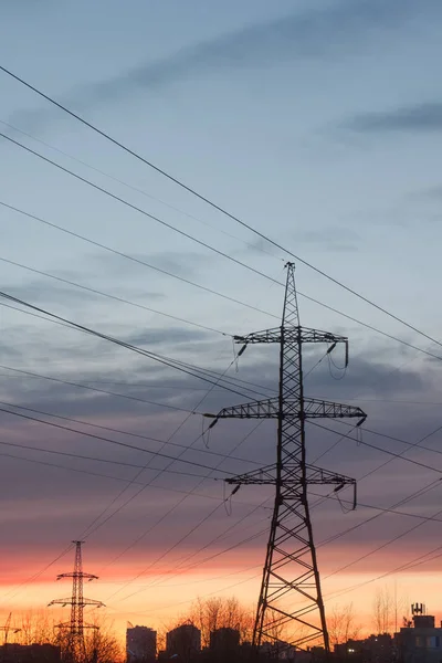 High-voltage electric main against the dark blue sky — Stock Photo, Image