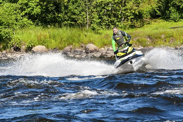 A man rides a water scooter along the Vuoks River — Stock Photo, Image