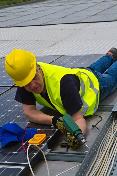 Geschoolde workerworking met fotovoltaïsche panelen — Stockfoto