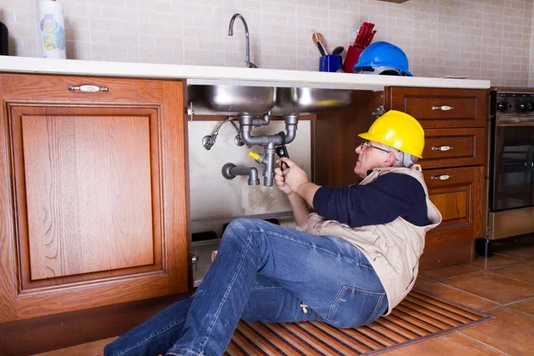 plumber at work to fix a sink