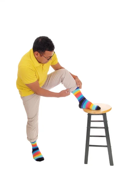 Man putting on his colorful socks. — Stock Photo, Image