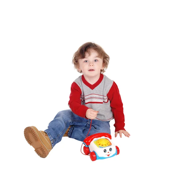 Portret van jongetje met zijn speelgoed telefoon. — Stockfoto