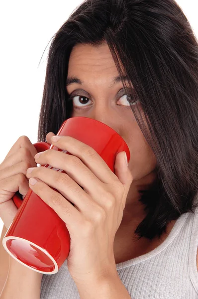 Beautiful Hispanic woman with red mug. — Stock Photo, Image