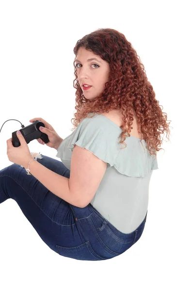 Woman sitting on floor playing her video game — Stock Photo, Image