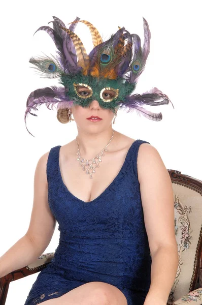 Woman sitting in blue dress and mask — Stock Photo, Image
