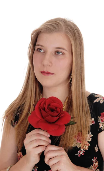 Träumende Frau mit roter Rose Stockfoto