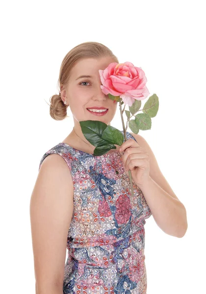 Woman standing in dress with rose on her face — Stock Photo, Image