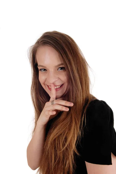 Woman holding finger over her mouth — Stock Photo, Image