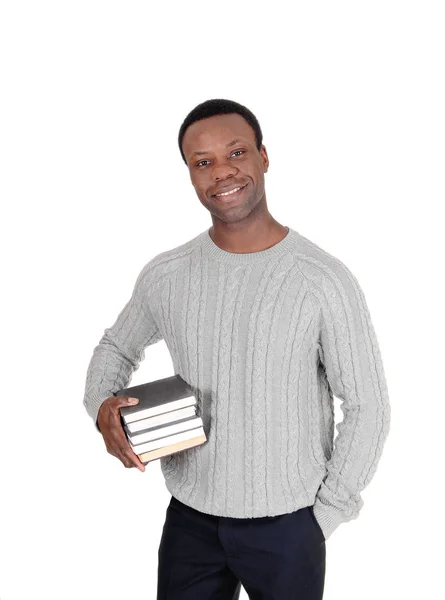 Hombre africano de pie con libros bajo sus brazos —  Fotos de Stock
