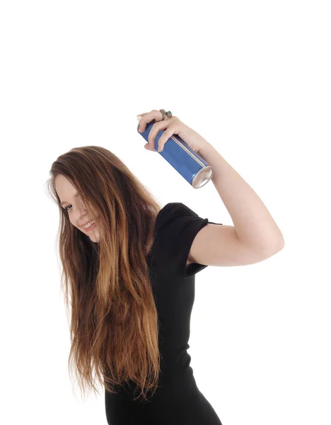 Woman putting hair spray on her hair — Stock Photo, Image