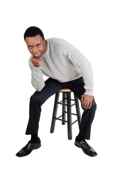 African man sitting on chair and thinking — Stock Photo, Image