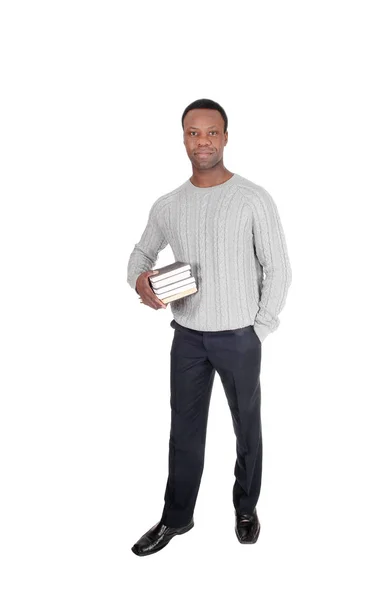 Hombre africano de pie con libros en sus manos —  Fotos de Stock