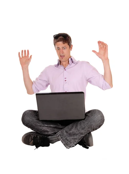 Scared man what he sees on his laptop — Stock Photo, Image