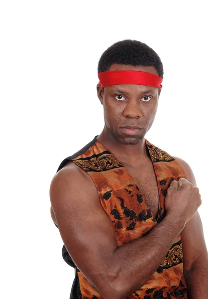 Serious looking African man in vest with his fist balled — Stock Photo, Image