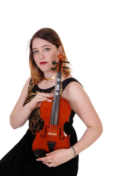 Woman sitting and holding her violin tight — Stock Photo, Image