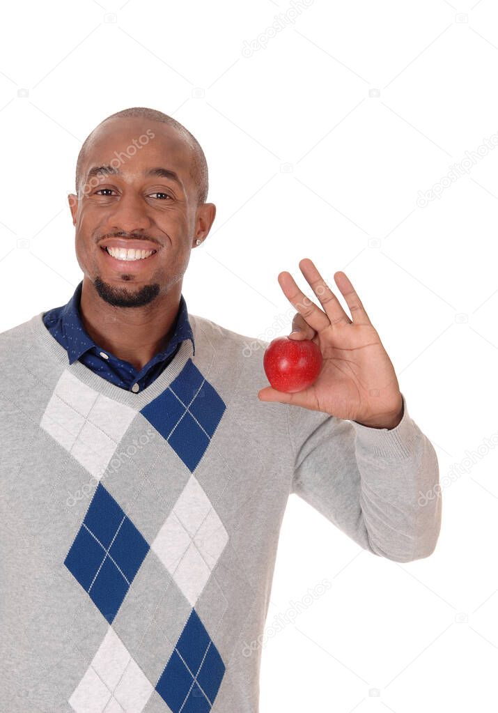 Handsome African man holding up a red apple