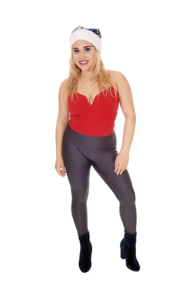 Frau in Strumpfhose, rotem Top und Weihnachtsmütze — Stockfoto