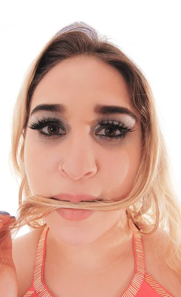 Close up head shoot of a woman with some hair in her mouth — Stock Photo, Image