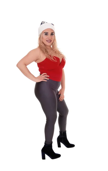 Woman standing in black tights, red top and Santa hat — ストック写真