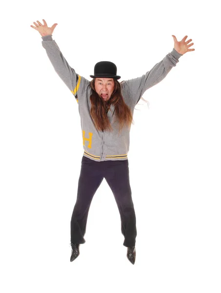 Happy jumping middle age man with long hair and hat — Stock Photo, Image