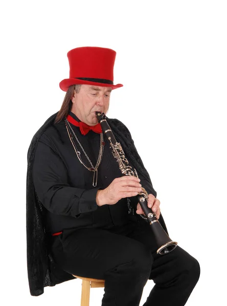 A clarinet player with a red hat and black outfit — Stock Photo, Image