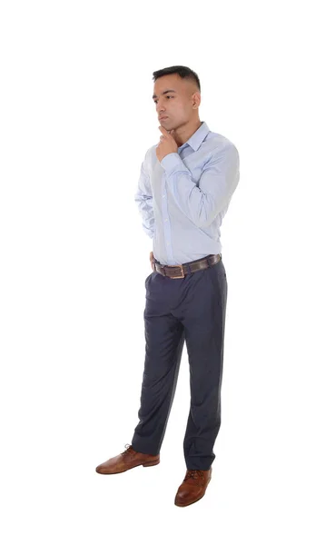 Young man standing with one hand under his chin — Stock Photo, Image