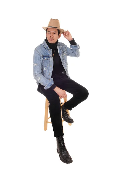 Young tall man sitting with a cowboy hat — Stock Photo, Image